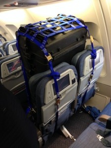 photo - Torah in traveling case strapped into two seats, compliments of Air Canada. 