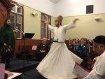 photo - David Coskun dances as Seemi Ghazi speaks