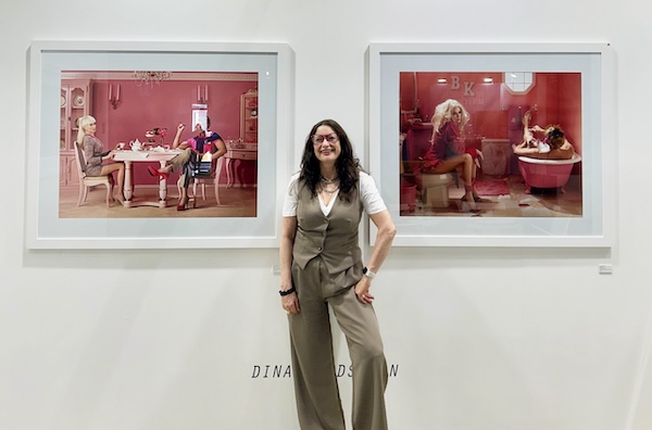 photo - Dina Goldstein stands in front of two of the 10 works that comprise her In the Dollhouse series featuring Barbie and Ken