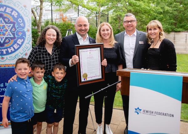 photo - Left to right are Rachel and Ezra Shanken with their children, Vancouver city councilors Sarah Kirby-Yung and Mike Klassen, and Jewish Federation of Greater Vancouver board chair Lana Marks Pulver. The City of Vancouver proclamation designated June 25, 2024, as Ezra Shanken Day, in honour of Shanken’s 10th anniversary as head of Federation