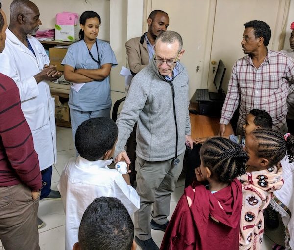 photo - Dr. Oheneba Boachie, left, and Dr. Rick Hodes, centre, with patients. The JDC spine program in Ethiopia is seeing patients full-time and has evaluated more than 5,000 patients with spine deformities