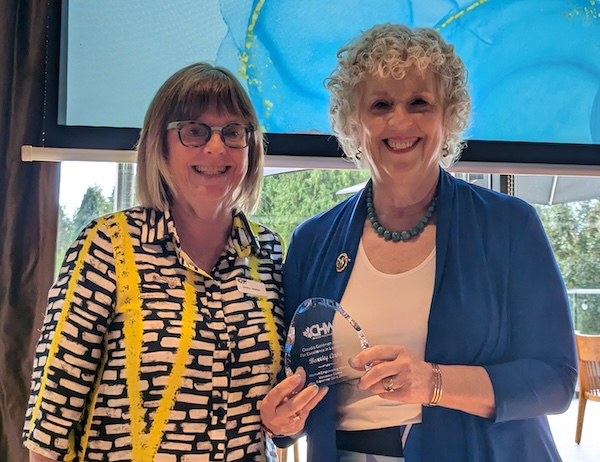 photo - Claudia Goldman, left, presents Bev Corber with the Claudia Goldman Award for Excellence in Leadership