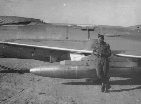 photo - A photo of Reuven Rashkovsky from the book An Improbable Life: My Father’s Escape from Soviet Russia, by his daughter, Dr. Karine Rashkovsky. Here, Reuven is pictured with a MIG 19 Soviet fighter plane. At 18, he was drafted into the military, conscripted for three years