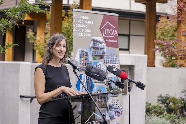 photo - Anat Gogo, executive director of Tikva Housing Society, speaks at the opening of Susana Cogan Place, Sept. 13, 2023