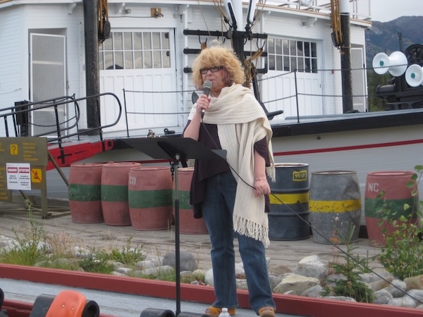 photo - Photos from the book include Joy Karp speaking to a group of people at a Terry Fox Run in Whitehorse